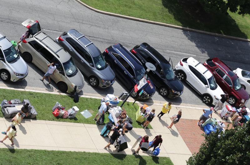 aerial view of cars parked in front of residence hall during moving day